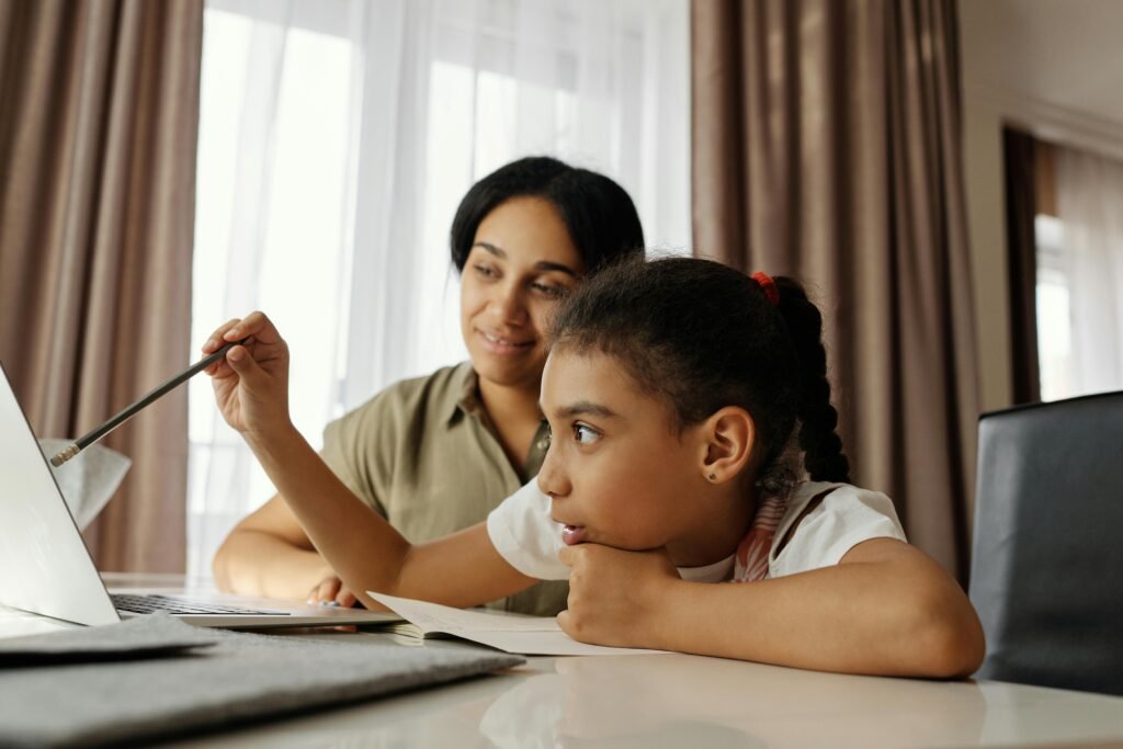 Compare Indexed Universal Life Insurance Mother and daughter engaged in online learning at home, using a laptop.