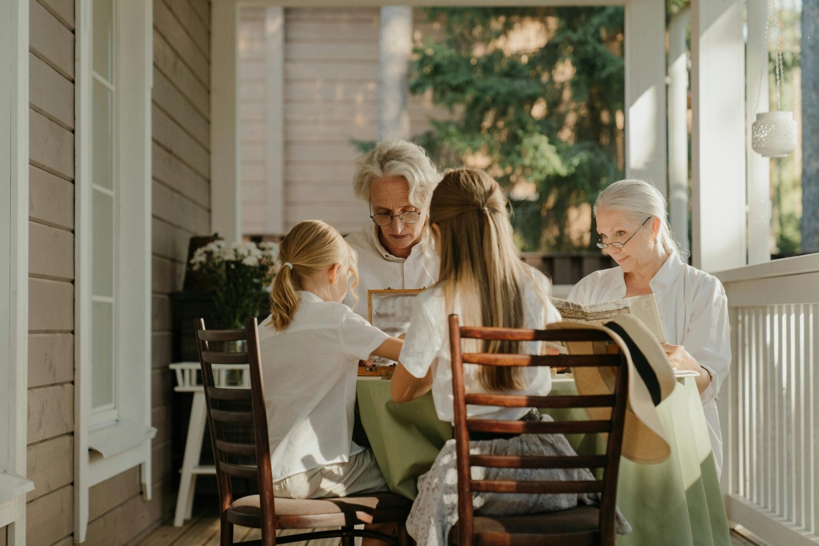 Home Multi-generational family sharing a moment on a sunlit veranda, capturing togetherness.